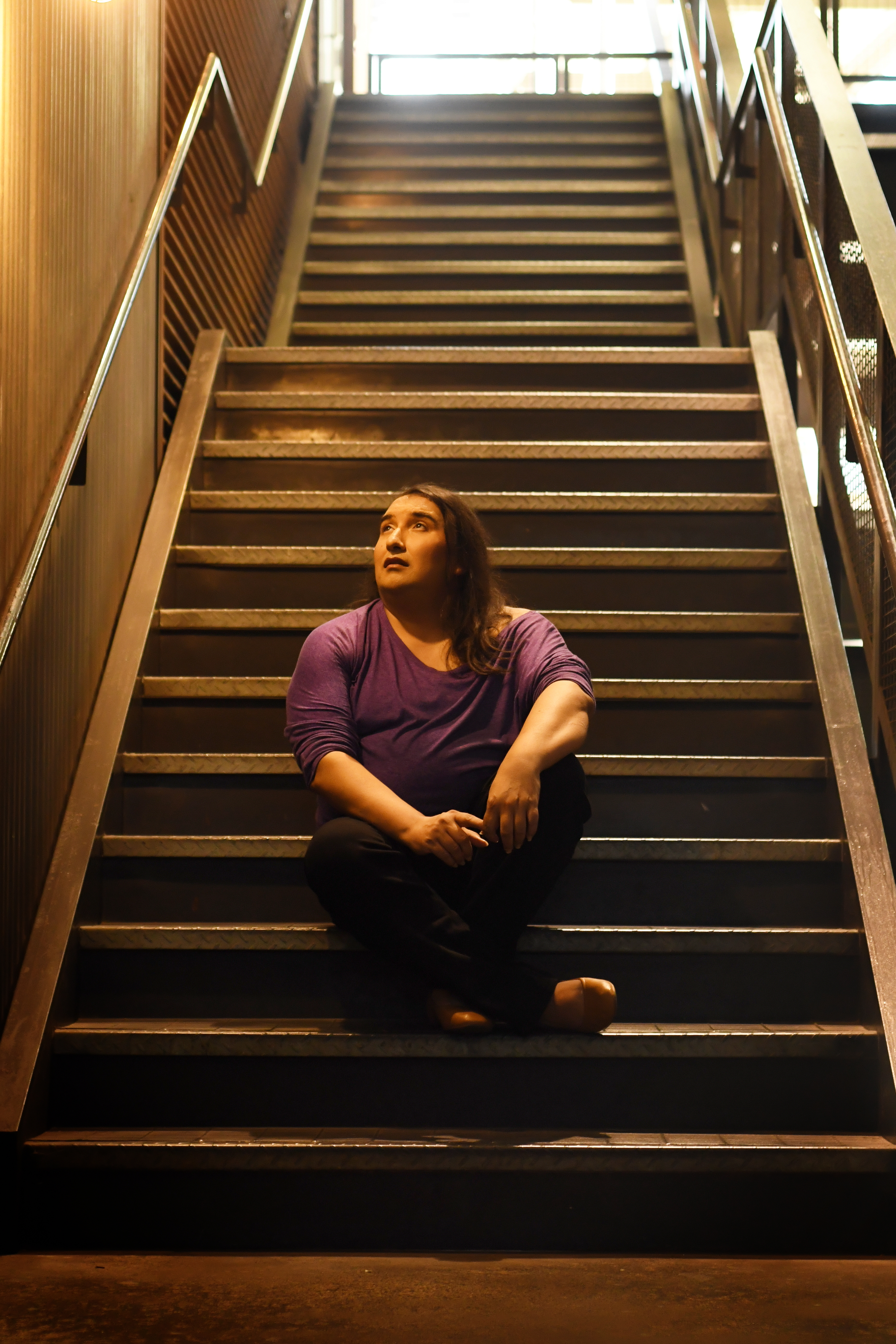 J.W. Sweem sitting on a staircase